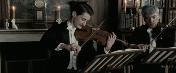 Movie still from “Frantz” (2016), directed by François Ozon – A man in a tuxedo playing a violin; Close Up shot, Low angle