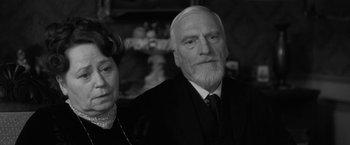 Movie still from “Frantz” (2016), directed by François Ozon – An older man and a younger woman are posing for a picture; Close Up shot, Low angle