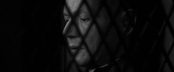 Movie still from “Frantz” (2016), directed by François Ozon – An old man in a suit is behind a fence; Close Up shot, Low angle