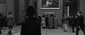 Movie still from “Frantz” (2016), directed by François Ozon – A group of people standing in front of a painting; Medium shot, Over the shoulder angle