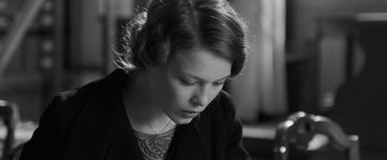 Movie still from “Frantz” (2016), directed by François Ozon – A woman with a tattoo is looking down at her face; Close Up shot, Over the shoulder angle