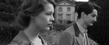 Movie still from “Frantz” (2016), directed by François Ozon – A woman and a man standing next to each other in front of a building; Close Up shot, Over the shoulder angle