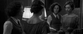 Movie still from “Frantz” (2016), directed by François Ozon – A woman looking in the mirror in front of a mirror; Medium shot, Over the shoulder angle