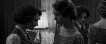 Movie still from “Frantz” (2016), directed by François Ozon – Two people standing next to each other in front of a lamp; Close Up shot, Over the shoulder angle