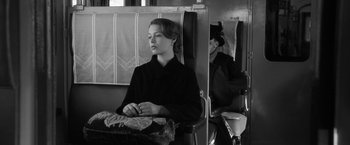 Movie still from “Frantz” (2016), directed by François Ozon – A woman sitting in a chair with her eyes closed; Medium shot, High angle