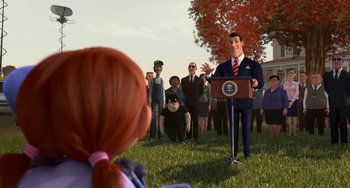 Movie still from “Free Birds” (2013), directed by Jimmy Hayward – An animated man is giving a speech in front of a group of people; Medium shot, Over the shoulder angle