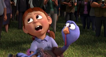 Movie still from “Free Birds” (2013), directed by Jimmy Hayward – A girl holding a turkey in her hand and a bird in her hand; Close Up shot, High angle