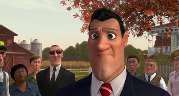 Movie still from “Free Birds” (2013), directed by Jimmy Hayward – A man in a suit and tie standing in front of two other men; Medium shot, Over the shoulder angle