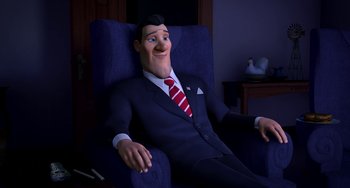 Movie still from “Free Birds” (2013), directed by Jimmy Hayward – A man sitting in a blue chair wearing a suit and tie; Medium shot, High angle