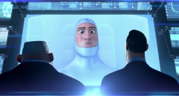 Movie still from “Free Birds” (2013), directed by Jimmy Hayward – Two men are looking at an image of a man in a spacesuit; Close Up shot, Over the shoulder angle