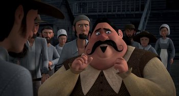 Movie still from “Free Birds” (2013), directed by Jimmy Hayward – A group of people standing around a man with a mustache; Medium shot, Over the shoulder angle