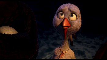 Movie still from “Free Birds” (2013), directed by Jimmy Hayward – An animated turkey looking at the camera in the dark; Close Up shot, High angle