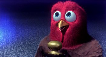 Movie still from “Free Birds” (2013), directed by Jimmy Hayward – A red bird with a gold knob in its mouth; Close Up shot, Low angle