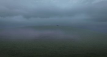 Movie still from “Free Birds” (2013), directed by Jimmy Hayward – Two people are standing on a hill in the fog; Extreme Wide shot, High angle