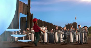 Movie still from “Free Birds” (2013), directed by Jimmy Hayward – A crowd of people standing in front of a man holding a box; Wide shot, High angle