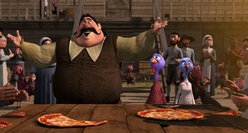 Movie still from “Free Birds” (2013), directed by Jimmy Hayward – A group of people standing around a table with pizza on top of it; Medium shot, Over the shoulder angle