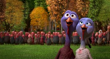 Movie still from “Free Birds” (2013), directed by Jimmy Hayward – A group of turkeys in a field with trees in the background; Medium shot, High angle