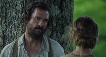 Movie still from “Free State of Jones” (2016), directed by Gary Ross – A person near a tree; Close Up shot, Over the shoulder angle