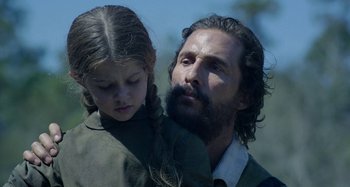Movie still from “Free State of Jones” (2016), directed by Gary Ross – A man and a little girl standing next to each other; Close Up shot, Low angle