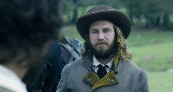Movie still from “Free State of Jones” (2016), directed by Gary Ross – A man with a long beard wearing a hat; Close Up shot, Over the shoulder angle