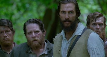 Movie still from “Free State of Jones” (2016), directed by Gary Ross – A man with a beard standing next to another man with a beard; Close Up shot, Low angle