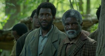 Movie still from “Free State of Jones” (2016), directed by Gary Ross – A group of men standing next to each other in a forest; Close Up shot, Low angle