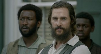 Movie still from “Free State of Jones” (2016), directed by Gary Ross – A man with a long beard standing next to another man with long hair; Close Up shot, Over the shoulder angle