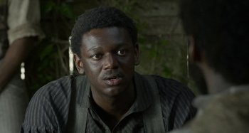 Movie still from “Free State of Jones” (2016), directed by Gary Ross – A person wearing a shirt and tie; Close Up shot, Over the shoulder angle