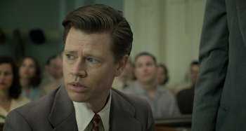 Movie still from “Free State of Jones” (2016), directed by Gary Ross – A person wearing a suit and tie; Close Up shot, Over the shoulder angle
