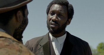 Movie still from “Free State of Jones” (2016), directed by Gary Ross – A man in a suit and tie looking to his left; Close Up shot, Over the shoulder angle