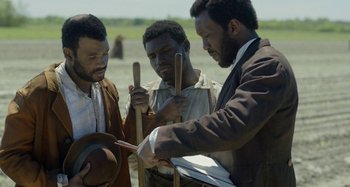 Movie still from “Free State of Jones” (2016), directed by Gary Ross – A group of men standing next to each other; Medium shot, High angle