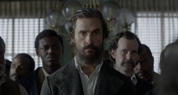 Movie still from “Free State of Jones” (2016), directed by Gary Ross – A group of men standing next to each other in a room; Close Up shot, Low angle