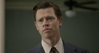 Movie still from “Free State of Jones” (2016), directed by Gary Ross – A person wearing a suit and tie; Close Up shot, Low angle