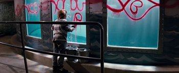 Movie still from “Free Willy” (1993), directed by Simon Wincer – A child is painting graffiti on a window; Wide shot, High angle