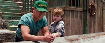 Movie still from “Free Willy” (1993), directed by Simon Wincer – A man and a boy sitting next to each other; Medium shot, Over the shoulder angle