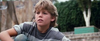 Movie still from “Free Willy” (1993), directed by Simon Wincer – A young boy is looking into the distance; Close Up shot, Low angle