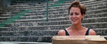 Movie still from “Free Willy” (1993), directed by Simon Wincer – A woman standing next to steps holding a box; Medium shot, Low angle