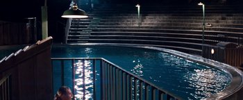 Movie still from “Free Willy” (1993), directed by Simon Wincer – A swimming pool with stairs in the background; Extreme Wide shot, High angle