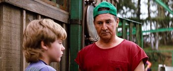 Movie still from “Free Willy” (1993), directed by Simon Wincer – An older man and a young boy are talking to each other; Medium shot, Over the shoulder angle