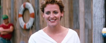 Movie still from “Free Willy” (1993), directed by Simon Wincer – A person wearing a white shirt smiling; Close Up shot, Low angle