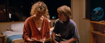 Movie still from “Free Willy” (1993), directed by Simon Wincer – A woman and a young boy sitting next to each other; Medium shot, Over the shoulder angle