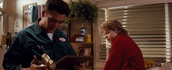 Movie still from “Free Willy” (1993), directed by Simon Wincer – A man and a boy looking at a book; Medium shot, Low angle