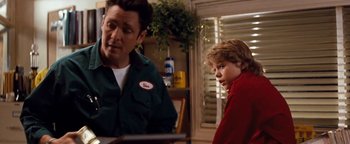 Movie still from “Free Willy” (1993), directed by Simon Wincer – A man and a boy sitting at a dining table; Medium shot, Over the shoulder angle