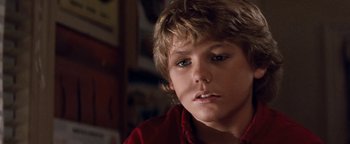 Movie still from “Free Willy” (1993), directed by Simon Wincer – A person with a red shirt on; Close Up shot, Low angle