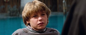 Movie still from “Free Willy” (1993), directed by Simon Wincer – A young boy with blonde hair wearing a gray shirt; Close Up shot, Low angle