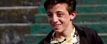 Movie still from “Free Willy” (1993), directed by Simon Wincer – A person smiling for the camera; Close Up shot, Low angle