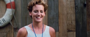 Movie still from “Free Willy” (1993), directed by Simon Wincer – A woman with short brown hair smiling for the camera; Close Up shot, Low angle