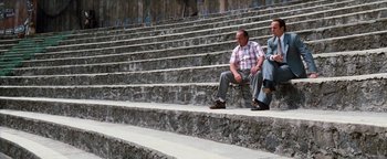 Movie still from “Free Willy” (1993), directed by Simon Wincer – A man and a woman sitting on some steps; Wide shot, High angle