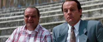 Movie still from “Free Willy” (1993), directed by Simon Wincer – A couple of men standing next to each other; Close Up shot, Low angle