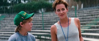Movie still from “Free Willy” (1993), directed by Simon Wincer – A woman standing next to a boy in a green hat; Medium shot, Over the shoulder angle